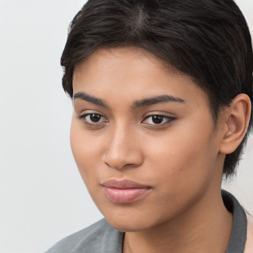 Joyful latino young-adult female with short  brown hair and brown eyes