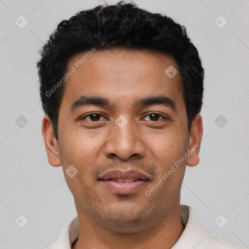 Joyful latino young-adult male with short  black hair and brown eyes