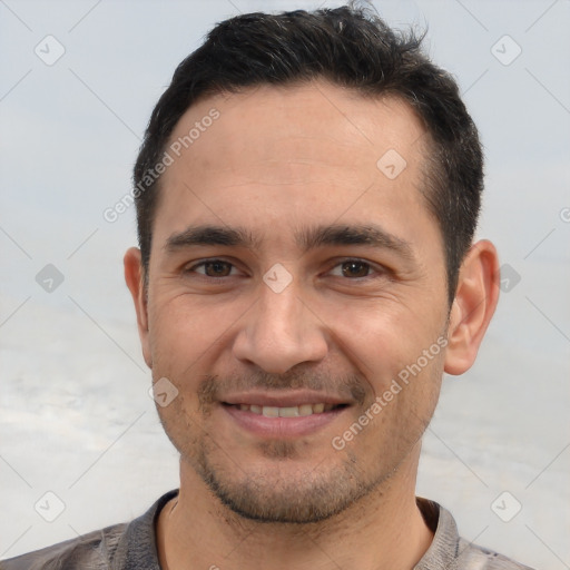 Joyful white young-adult male with short  brown hair and brown eyes