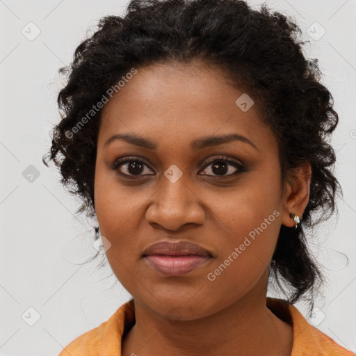 Joyful black young-adult female with long  brown hair and brown eyes