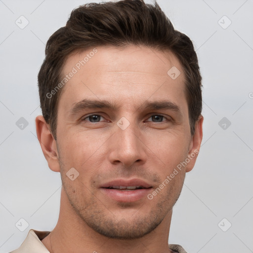 Joyful white young-adult male with short  brown hair and grey eyes