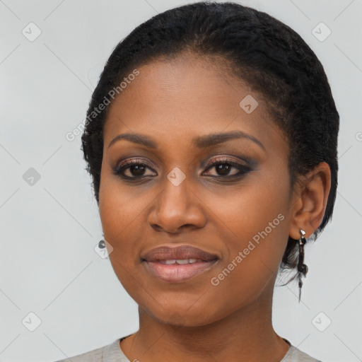 Joyful black young-adult female with short  black hair and brown eyes