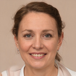 Joyful white adult female with medium  brown hair and brown eyes