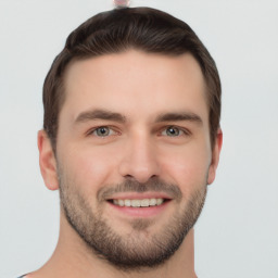 Joyful white young-adult male with short  brown hair and grey eyes