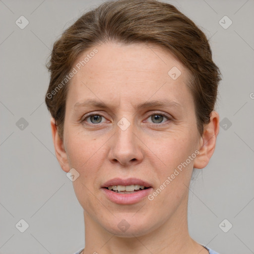 Joyful white adult female with short  brown hair and grey eyes