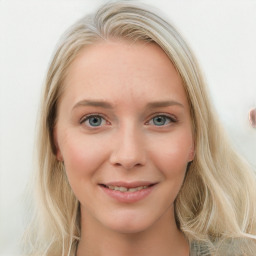 Joyful white young-adult female with long  brown hair and blue eyes