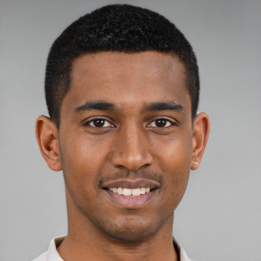 Joyful black young-adult male with short  brown hair and brown eyes