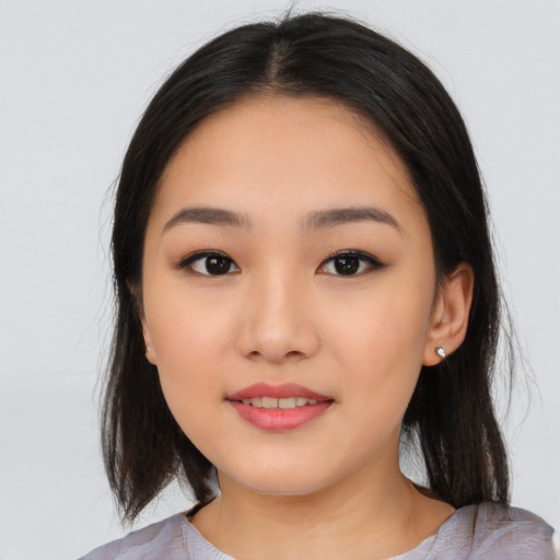 Joyful asian young-adult female with medium  black hair and brown eyes