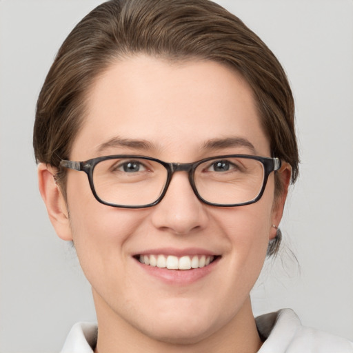 Joyful white young-adult female with short  brown hair and grey eyes