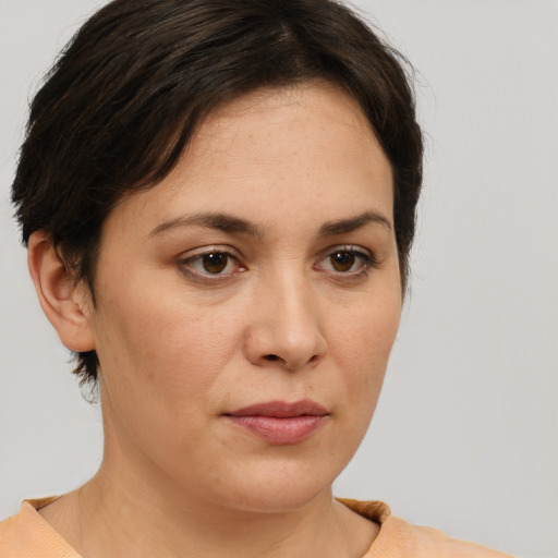 Joyful white adult female with short  brown hair and brown eyes