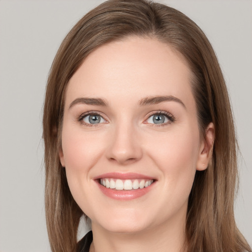 Joyful white young-adult female with long  brown hair and grey eyes