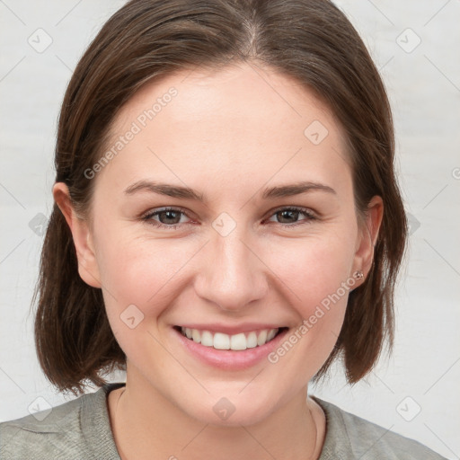 Joyful white young-adult female with medium  brown hair and grey eyes