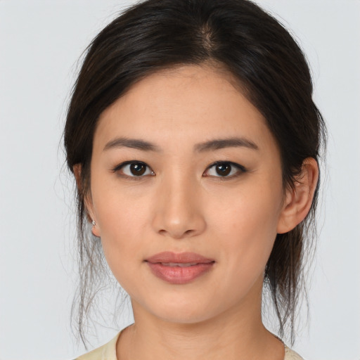 Joyful asian young-adult female with medium  brown hair and brown eyes