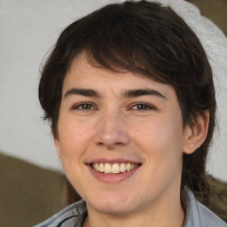 Joyful white young-adult male with medium  brown hair and brown eyes