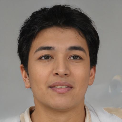 Joyful asian young-adult male with short  brown hair and brown eyes