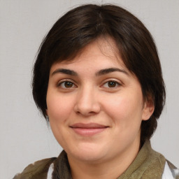 Joyful white young-adult female with medium  brown hair and brown eyes