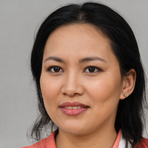 Joyful asian young-adult female with long  brown hair and brown eyes