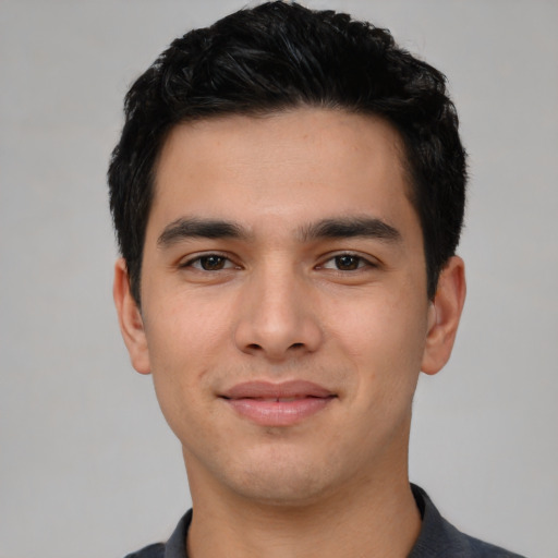 Joyful latino young-adult male with short  black hair and brown eyes