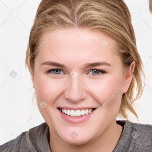 Joyful white young-adult female with medium  brown hair and blue eyes