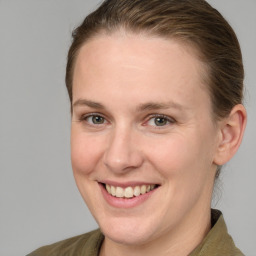 Joyful white adult female with medium  brown hair and grey eyes