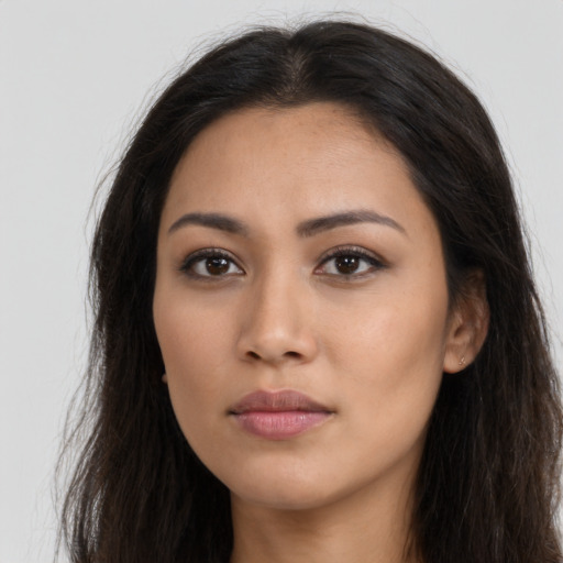 Neutral latino young-adult female with long  brown hair and brown eyes