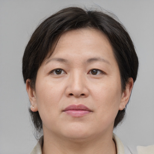 Neutral asian adult female with medium  brown hair and brown eyes