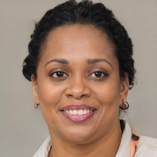 Joyful latino adult female with short  brown hair and brown eyes