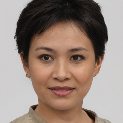 Joyful asian young-adult female with short  brown hair and brown eyes