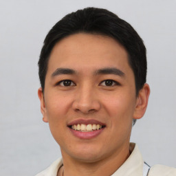 Joyful asian young-adult male with short  black hair and brown eyes