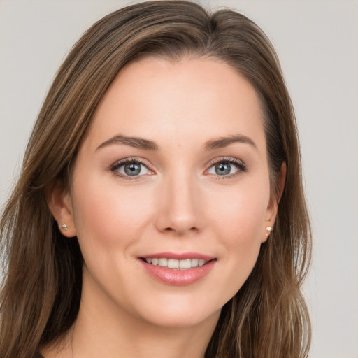 Joyful white young-adult female with long  brown hair and grey eyes