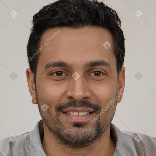 Joyful latino young-adult male with short  black hair and brown eyes