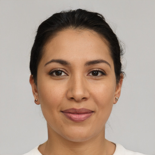 Joyful latino young-adult female with medium  brown hair and brown eyes