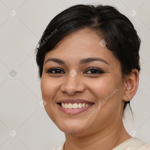 Joyful latino young-adult female with medium  brown hair and brown eyes