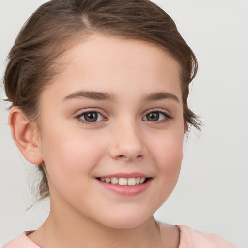 Joyful white child female with medium  brown hair and brown eyes