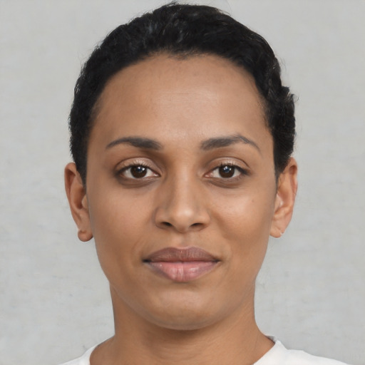 Joyful latino young-adult female with short  black hair and brown eyes