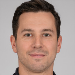 Joyful white young-adult male with short  brown hair and brown eyes