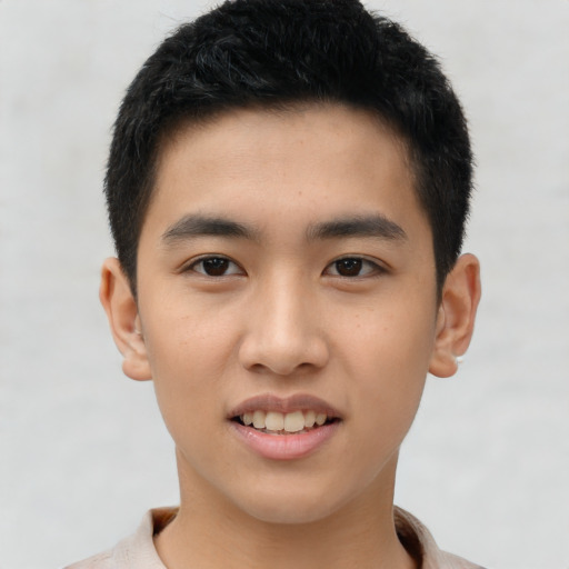 Joyful asian young-adult male with short  brown hair and brown eyes