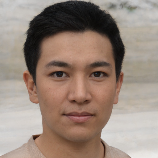 Joyful asian young-adult male with short  black hair and brown eyes