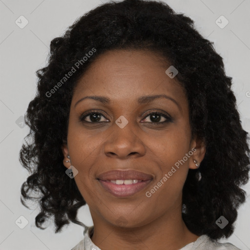 Joyful black adult female with medium  brown hair and brown eyes