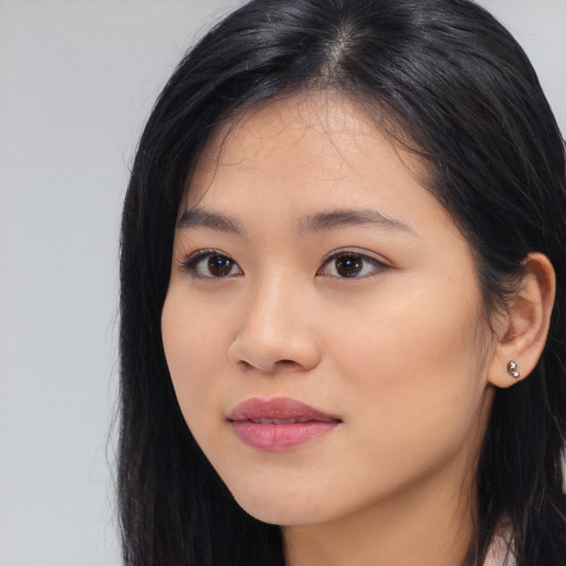 Joyful white young-adult female with long  black hair and brown eyes