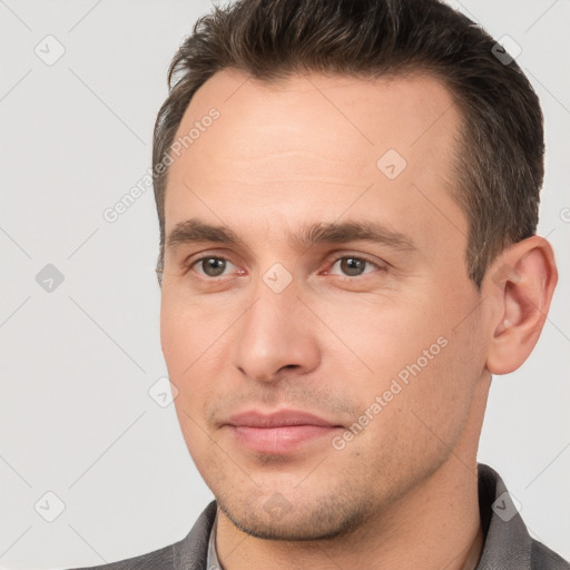 Joyful white young-adult male with short  brown hair and brown eyes