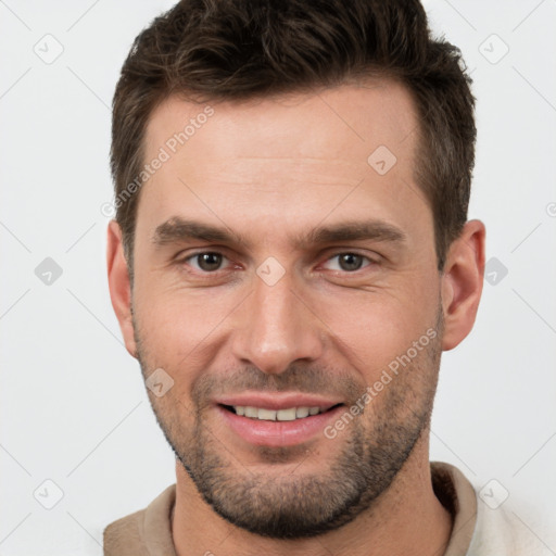 Joyful white young-adult male with short  brown hair and brown eyes