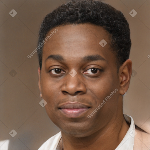 Joyful black young-adult male with short  brown hair and brown eyes