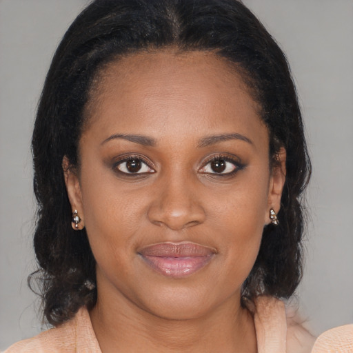 Joyful black young-adult female with medium  brown hair and brown eyes