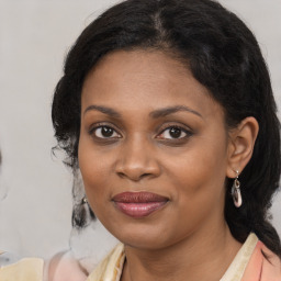 Joyful black young-adult female with medium  brown hair and brown eyes