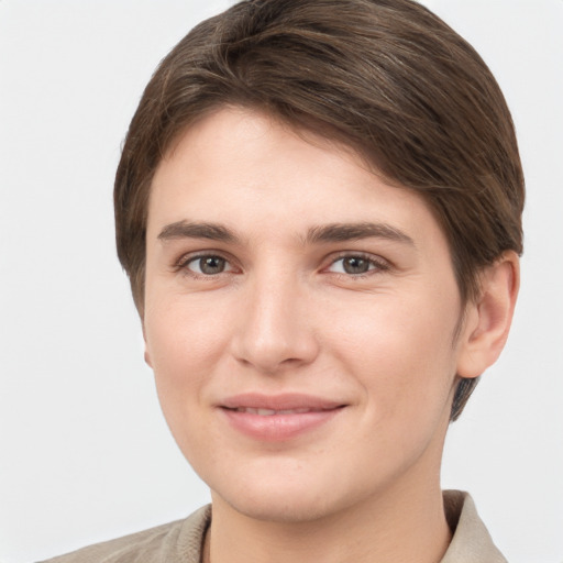 Joyful white young-adult female with short  brown hair and grey eyes