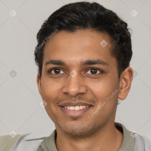 Joyful latino young-adult male with short  brown hair and brown eyes