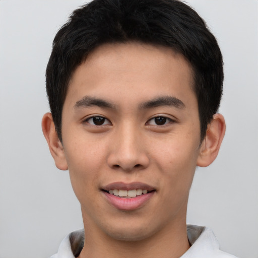 Joyful asian young-adult male with short  brown hair and brown eyes