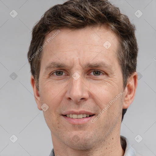 Joyful white adult male with short  brown hair and grey eyes