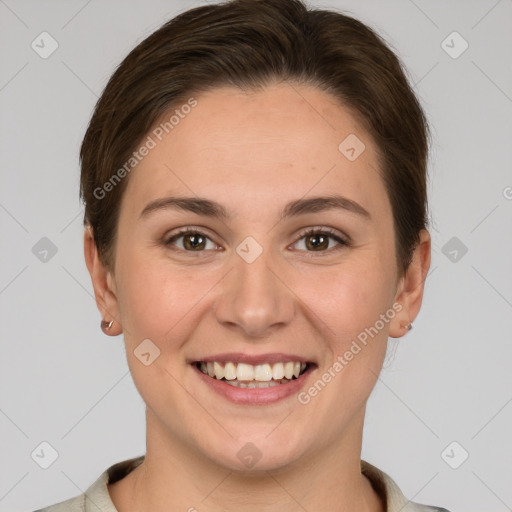 Joyful white young-adult female with short  brown hair and grey eyes